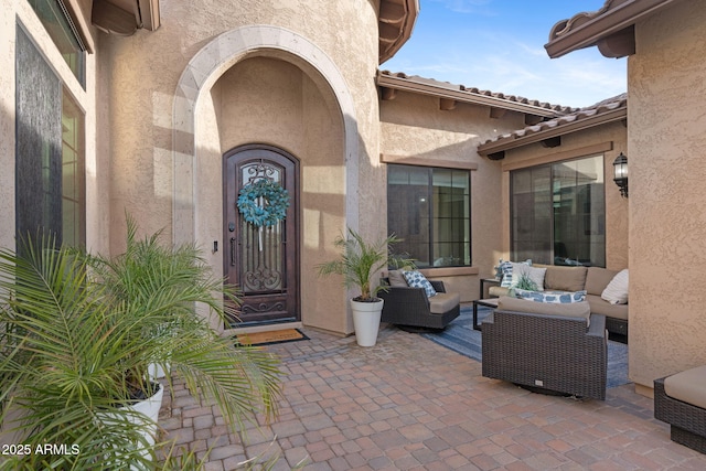 entrance to property featuring an outdoor hangout area and a patio area