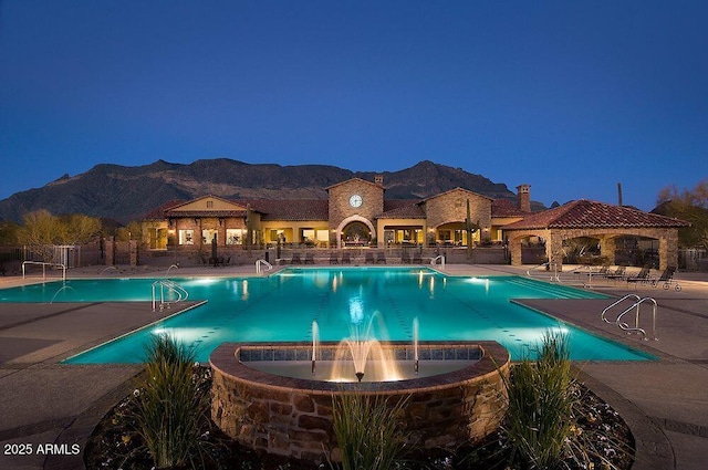 view of swimming pool featuring a mountain view, a patio area, and pool water feature