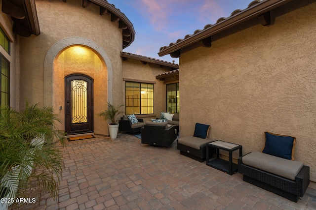 exterior space with an outdoor hangout area and a patio area