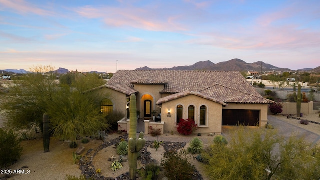 mediterranean / spanish-style house featuring a mountain view and a garage