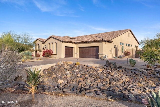 mediterranean / spanish home with a garage