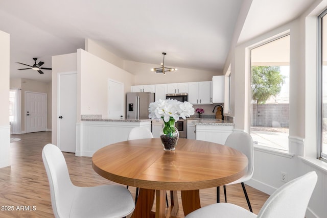 8103 E Dartmouth St, Mesa, AZ 85207 - dining space with lofted ceiling, a chandelier, light wood-style floors, a ceiling fan, and baseboards