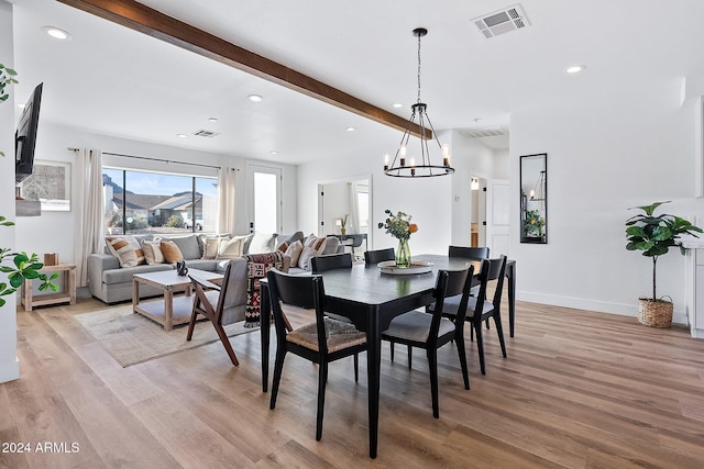 dining room featuring beam ceiling, light hardwood / wood-style floors, and a notable chandelier