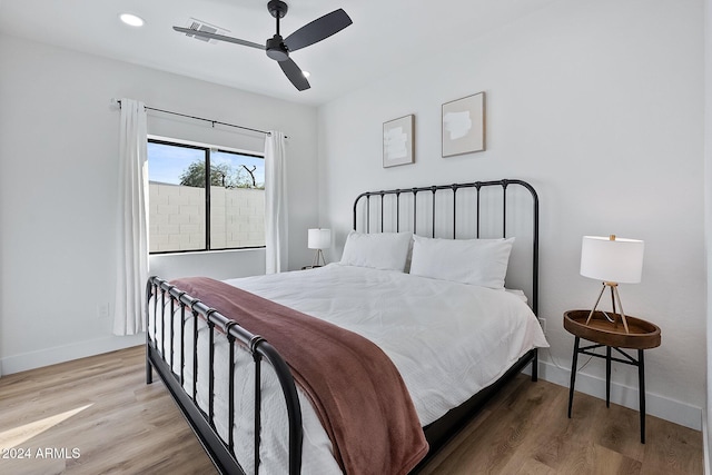 bedroom with ceiling fan and hardwood / wood-style flooring