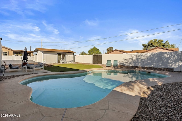 view of swimming pool featuring an outdoor living space, a yard, and a patio