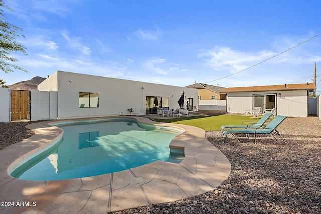 view of swimming pool with a patio area and a yard