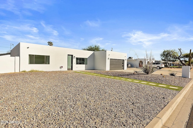 pueblo revival-style home with a garage