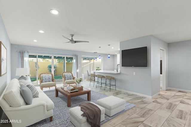 living room with recessed lighting, ceiling fan, and baseboards