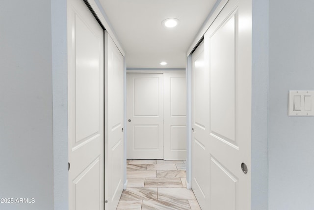 hallway featuring marble finish floor and recessed lighting