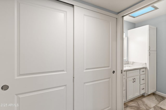 bathroom with marble finish floor and vanity