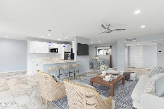 living area with marble finish floor, recessed lighting, visible vents, ceiling fan, and baseboards