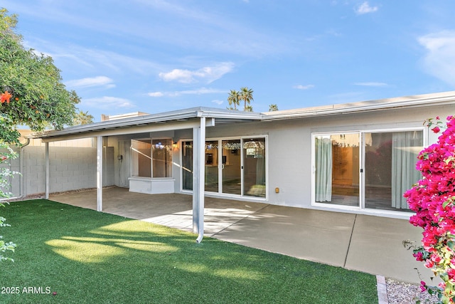 rear view of house featuring a yard, a patio area, and fence