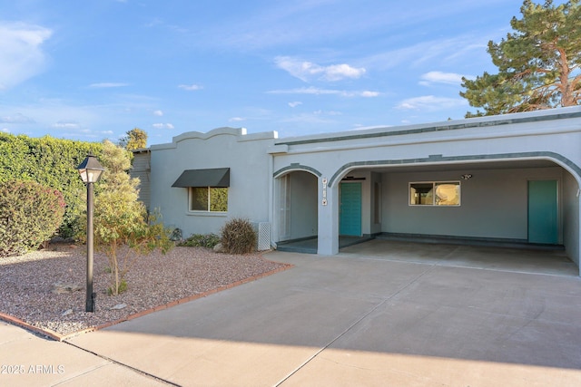 mediterranean / spanish house featuring concrete driveway and stucco siding