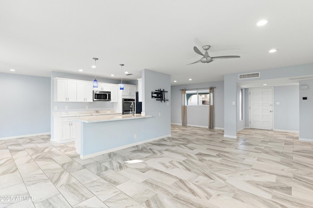 kitchen featuring visible vents, a ceiling fan, stainless steel appliances, light countertops, and white cabinetry