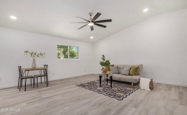 sitting room with ceiling fan, lofted ceiling, and light hardwood / wood-style floors