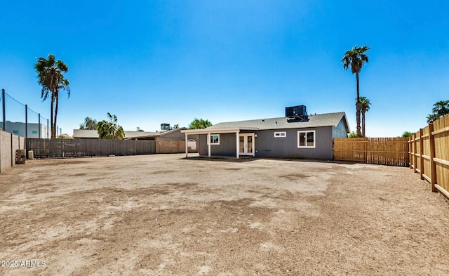 rear view of property with central AC unit and french doors