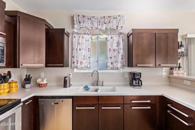 kitchen with dark brown cabinetry, sink, and stainless steel appliances