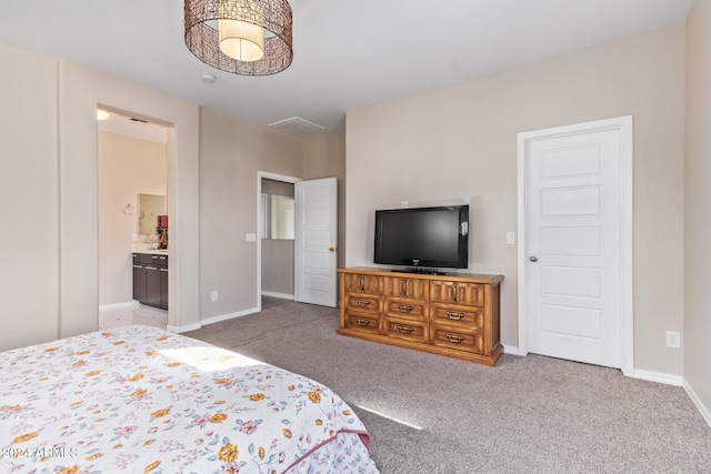 bedroom with connected bathroom and light colored carpet