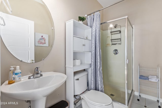 bathroom featuring tile patterned flooring, toilet, curtained shower, and sink