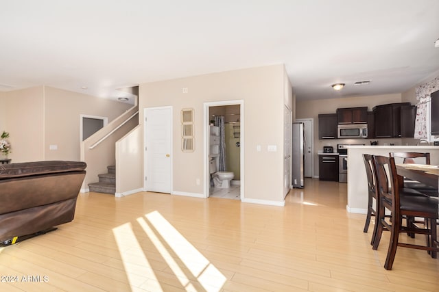 living room featuring light wood-type flooring and sink