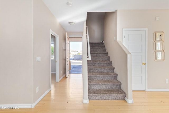 stairway featuring hardwood / wood-style floors