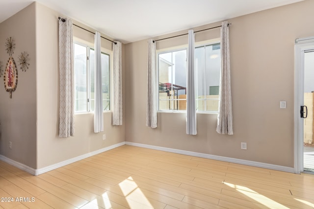 unfurnished room with light hardwood / wood-style flooring