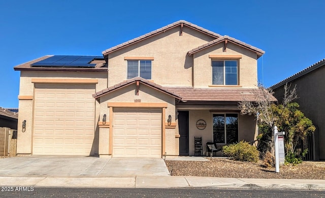 traditional-style home featuring solar panels, a tiled roof, concrete driveway, and stucco siding