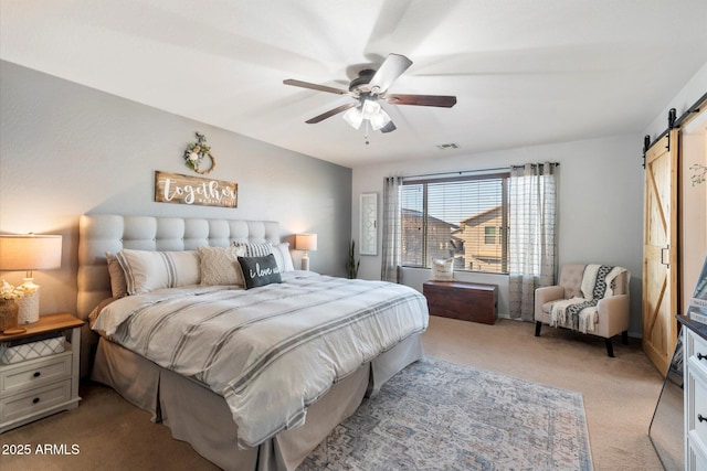 bedroom with visible vents, ceiling fan, carpet, and a barn door