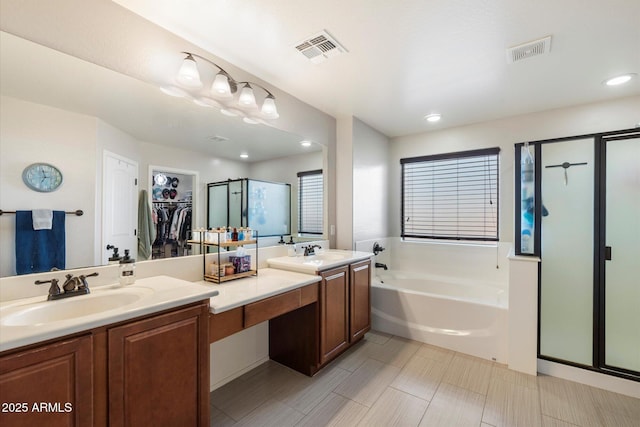 bathroom with a sink, visible vents, and a stall shower