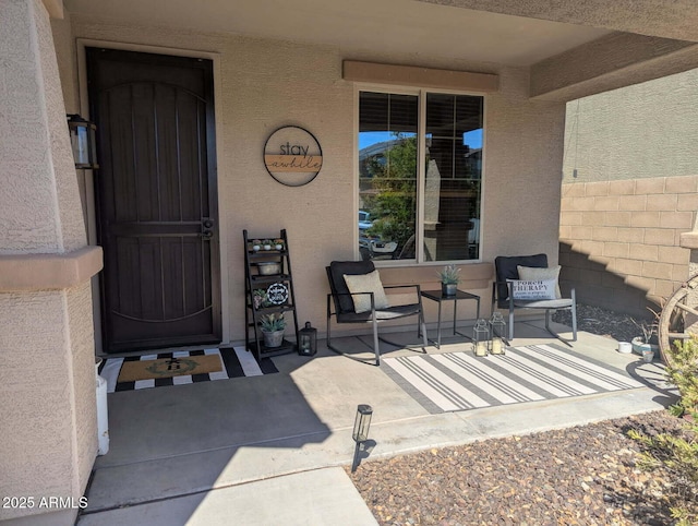 doorway to property with a patio area and stucco siding