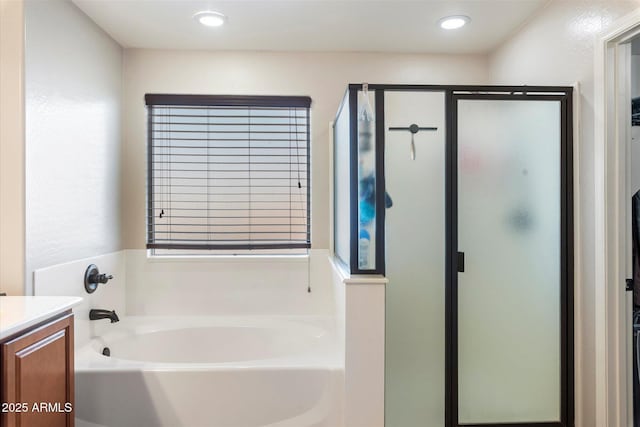 full bathroom with vanity, a garden tub, recessed lighting, and a stall shower