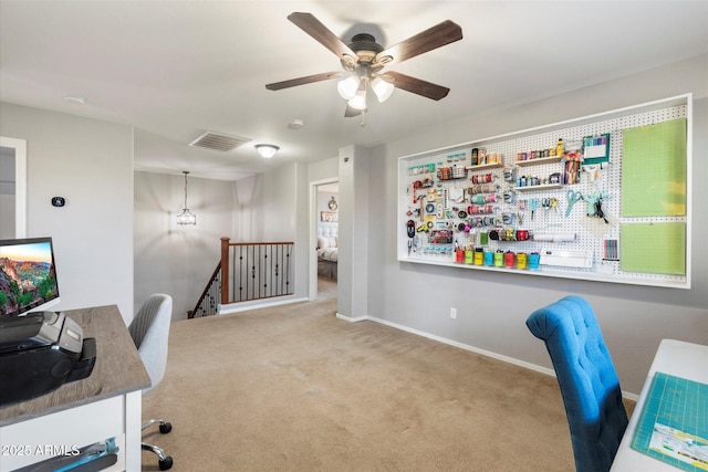 carpeted office space with visible vents, baseboards, and a ceiling fan