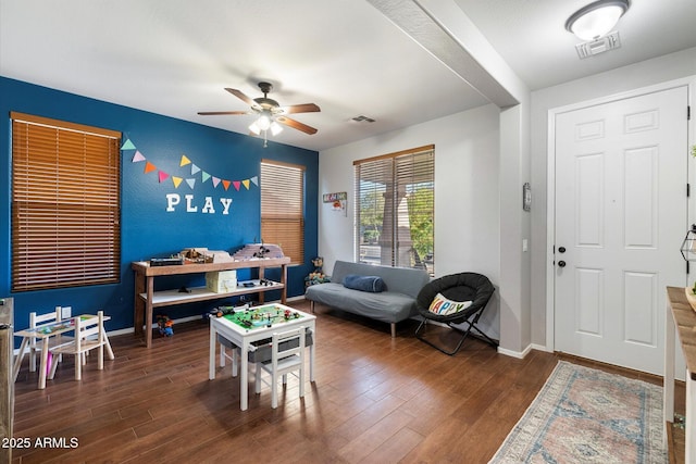 interior space featuring a ceiling fan, wood finished floors, and visible vents