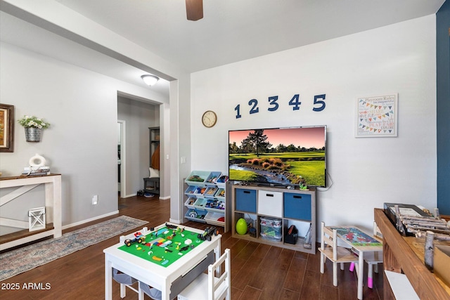 playroom with baseboards, a ceiling fan, and wood finished floors