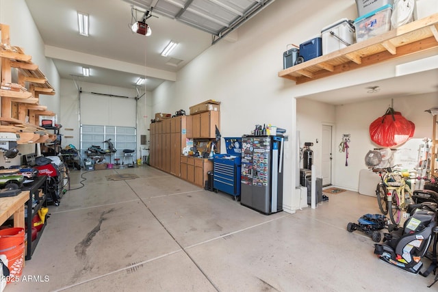 garage with a workshop area and a garage door opener