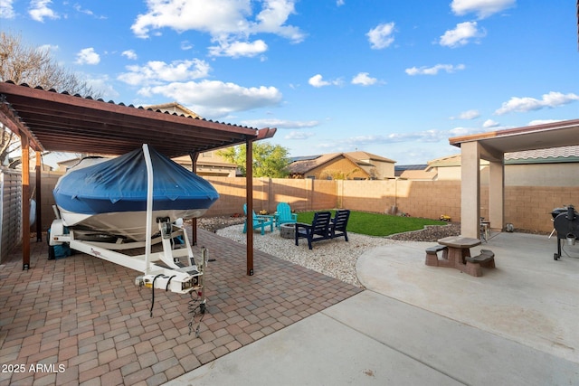 view of patio with a fenced backyard and an outdoor fire pit