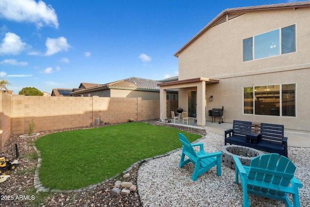 view of yard featuring a patio area, an outdoor fire pit, and a fenced backyard