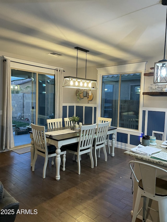 dining room featuring dark wood-type flooring and visible vents