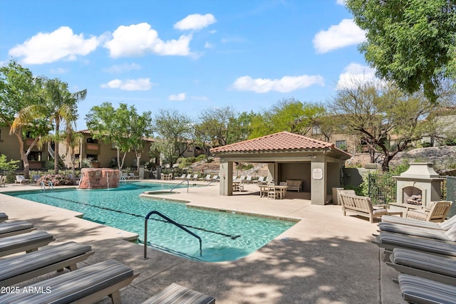 5751 N Kolb Rd Unit 7102, Tucson, AZ 85750 - pool with a patio area and an outdoor fireplace