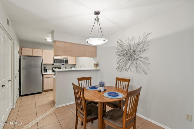 5751 N Kolb Rd Unit 7102, Tucson, AZ 85750 - dining space featuring light tile patterned floors, baseboards, and visible vents