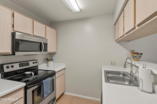 5751 N Kolb Rd Unit 7102, Tucson, AZ 85750 - kitchen with light tile patterned floors, light countertops, stainless steel appliances, a sink, and light brown cabinetry