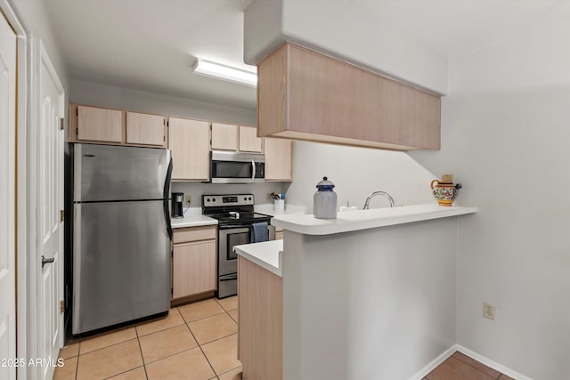 5751 N Kolb Rd Unit 7102, Tucson, AZ 85750 - kitchen featuring a peninsula, light tile patterned floors, light countertops, appliances with stainless steel finishes, and light brown cabinetry