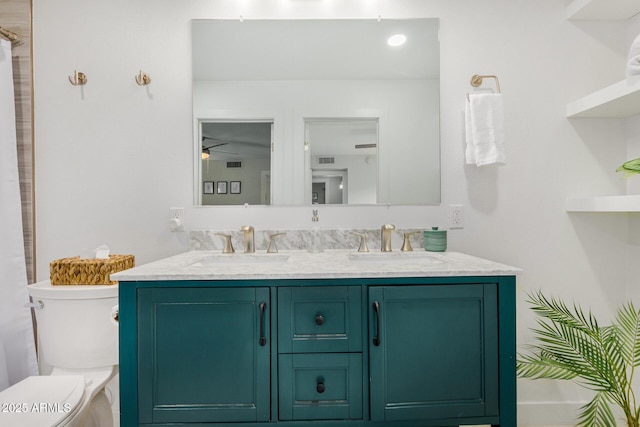 bathroom featuring vanity and toilet