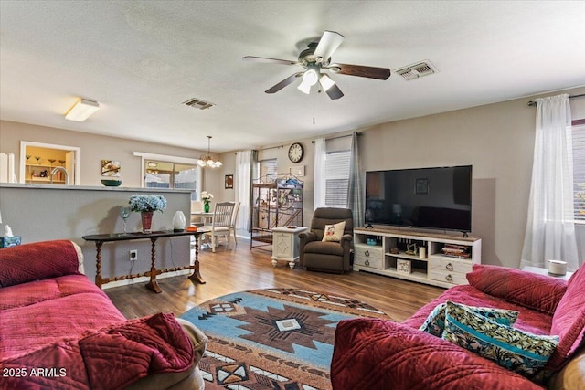 1057 E Silversmith Trl, San Tan Valley, AZ 85143 - living area with a ceiling fan, a chandelier, and wood finished floors