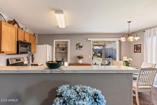 1057 E Silversmith Trl, San Tan Valley, AZ 85143 - kitchen with black microwave, white refrigerator with ice dispenser, stove, a chandelier, and a peninsula
