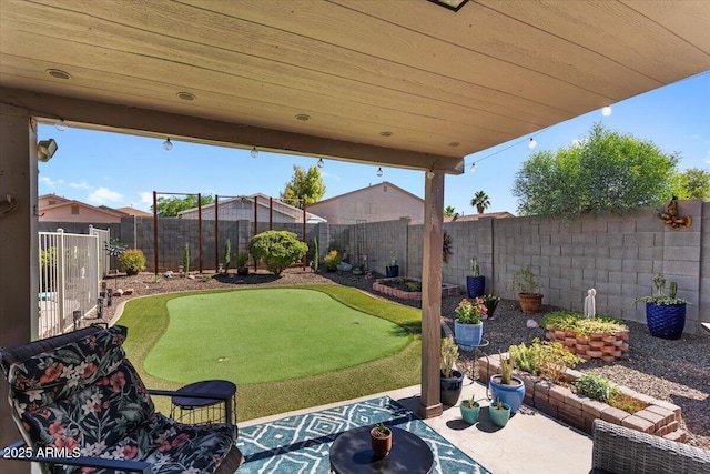 1057 E Silversmith Trl, San Tan Valley, AZ 85143 - fenced backyard with an area to practice putting and a patio area