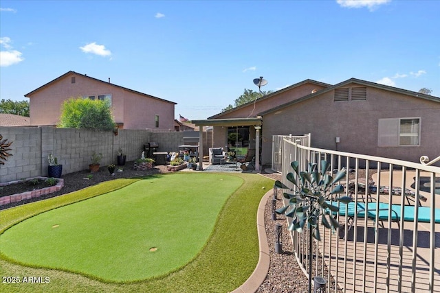 1057 E Silversmith Trl, San Tan Valley, AZ 85143 - fenced backyard with an area to practice putting and a patio area