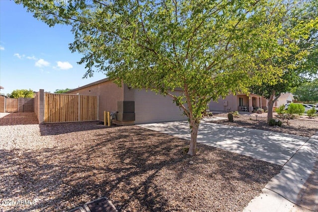 1057 E Silversmith Trl, San Tan Valley, AZ 85143 - view of home's exterior with an attached garage, stucco siding, and driveway