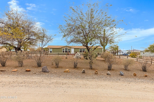 view of front of house featuring fence and a wooden deck