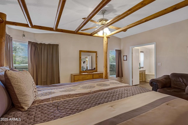 bedroom with vaulted ceiling with beams and ensuite bathroom